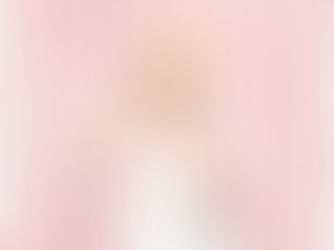 a little girl with blonde hair wears a paper crown and smiles precociously