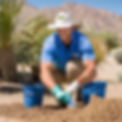 2 good looking professional landscapers wearing blue uniforms wearing caps taking a soil s