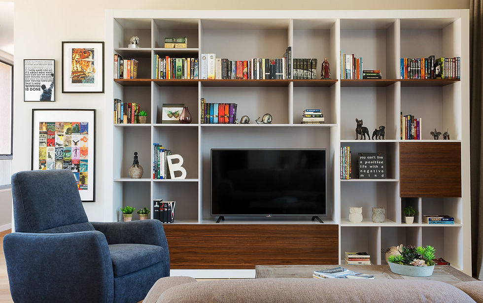 Modern media unit with walnut details, styled with books and ornaments. 