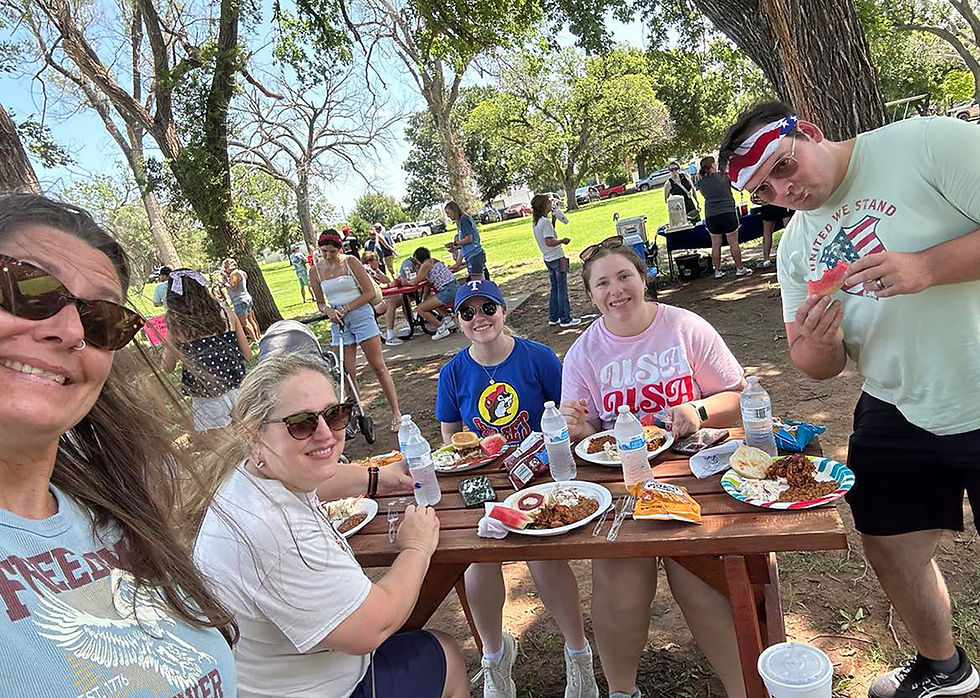 People attending the annual Fourth of July festivities at Cherokee City Park enjoy a barbecue pork lunch.