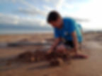 A young boy digs in a hole while digging crystals at the Selenite Crystal Digging Area in Alfalfa County, Oklahoma.