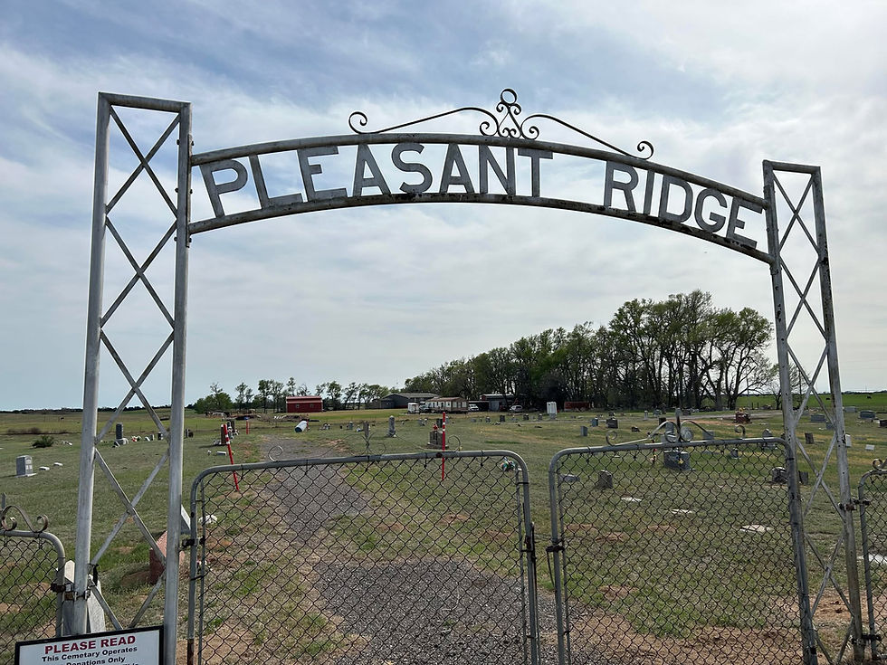 A steel archway built by members of Home Welfare Club serves as the entryway to Pleasant Ridge Cemetery Aline.