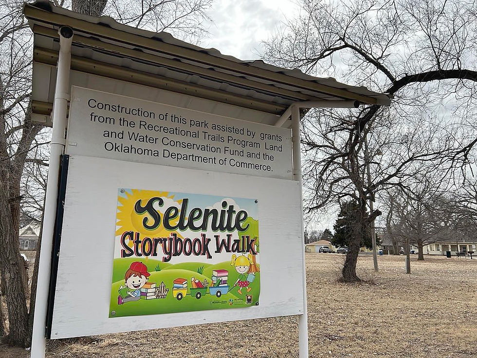 A sign at Cherokee Nature Park reads: "Construction of this park assisted by grants from the Recreational Trails Program Land and Water Conservation Fund and the Oklahoma Department of Commerce." It also shows the title of the walking trail theme, which is "Selenite Storybook Walk."