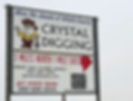 The sign pointing to the crystal digging area along U.S. 64 west of Jet, Oklahoma, features Selenite Sam and an arrow pointing north and directions "3 miles north, 1 mile east." The sign is sponsored by Great Salt Plains Assoc. 580-596-3053, greatsaltplains.com, Jet State Bank 580-626-4434.