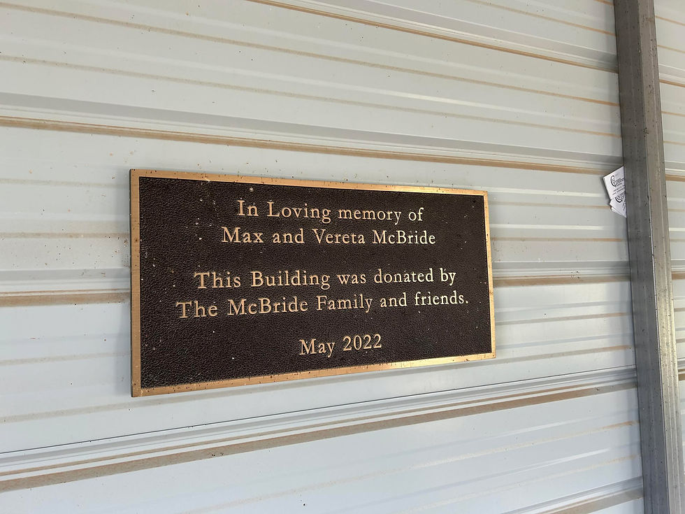 A plaque inside the community building notes the donation of the shelter in 2022 in loving memory of Max and Vereta McBride.