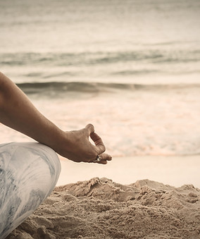 person in blue shorts sitting on beach s
