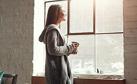 Relax coffee and woman looking out window from her home thinking