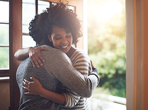 Missed you so much, babe. Shot of a young couple embracing by the doorway to their house