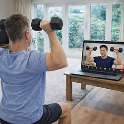 Client completing an online personal training session at home with a coach providing live guidance via video call