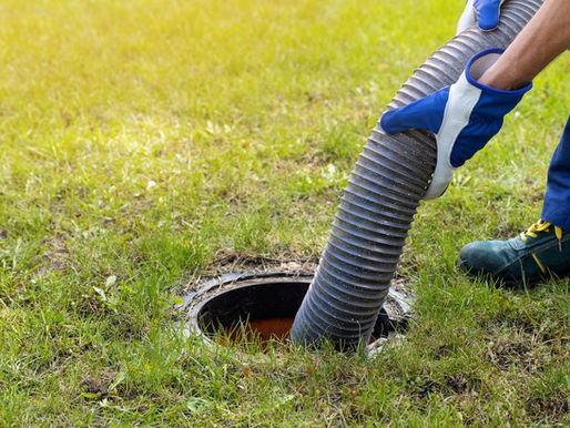 Man cleaning a septic tank with hose | Corey's Construction PA