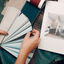Person looking at color swatches for interior design | Corey Construction