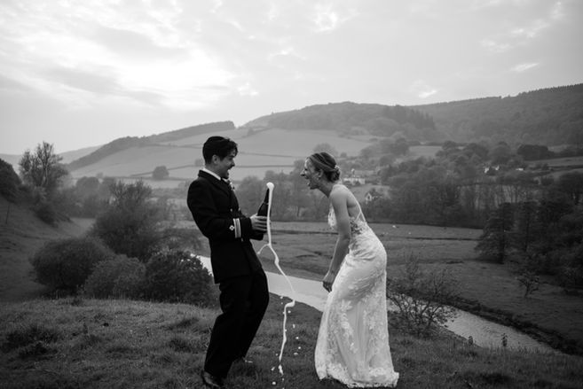 wedding couple laughing with champagne