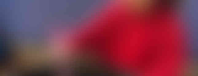 Young girl uses chopsticks with woollen ‘noodles’ as part of messy play and cooking projects with toddlers at Shining Stars Nursery in Cardiff