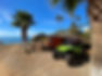 Green UTV next to a house on the beach in Baja facing the ocean