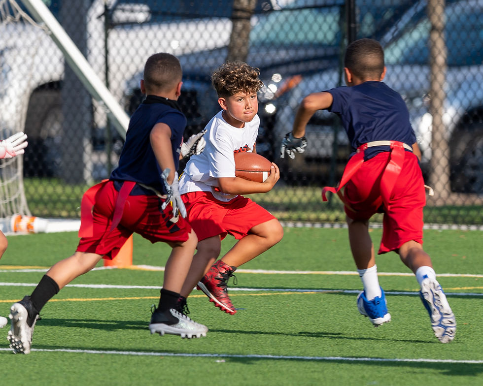 A youth flag football athlete in South Riding successfully pulling a flag during a repetition drill.
