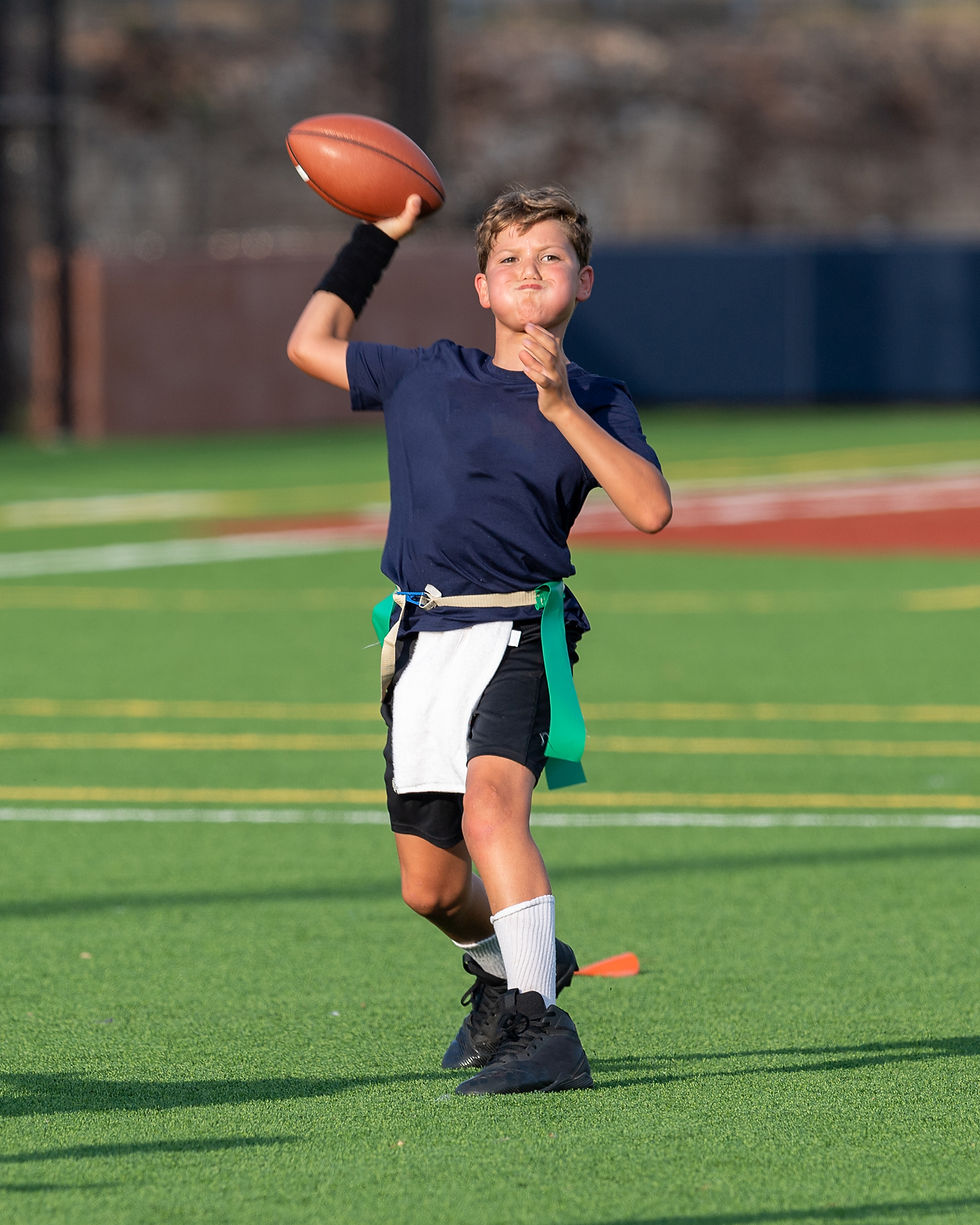 First-time youth flag football player throwing a short pass during practice in Gainesville.