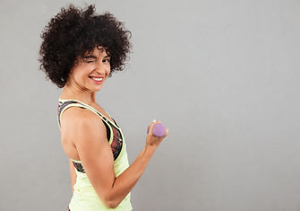 side-view-pleased-fitness-woman-doing-exercise-with-dumbbell.jpg