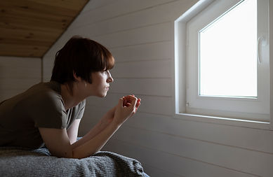 medium-shot-woman-looking-out-window.jpg