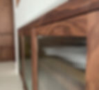 Custom-made walnut built-in cabinets with reeded glass faces.
