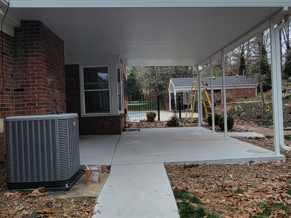 White aluminum patio cover built over a concrete patio at a brick ranch home, fabricated by All Weather Products in Evansville, Indiana.