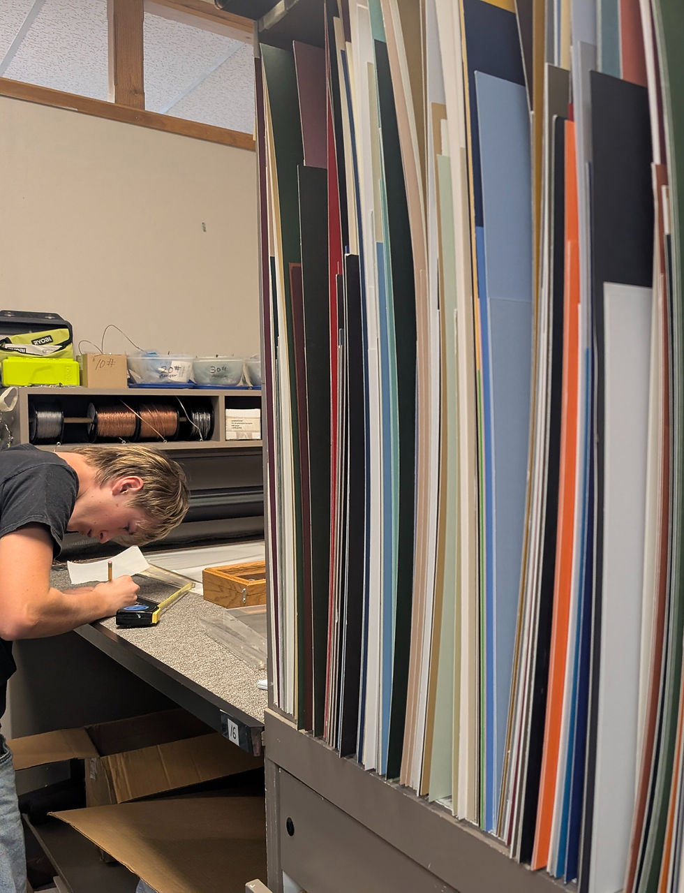 Craftsperson selecting mat boards for picture framing