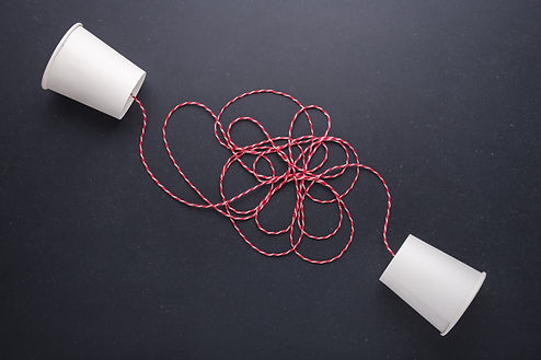 A conversation, represented by two cups on a string, waits to be picked up to start a conversation that matters.