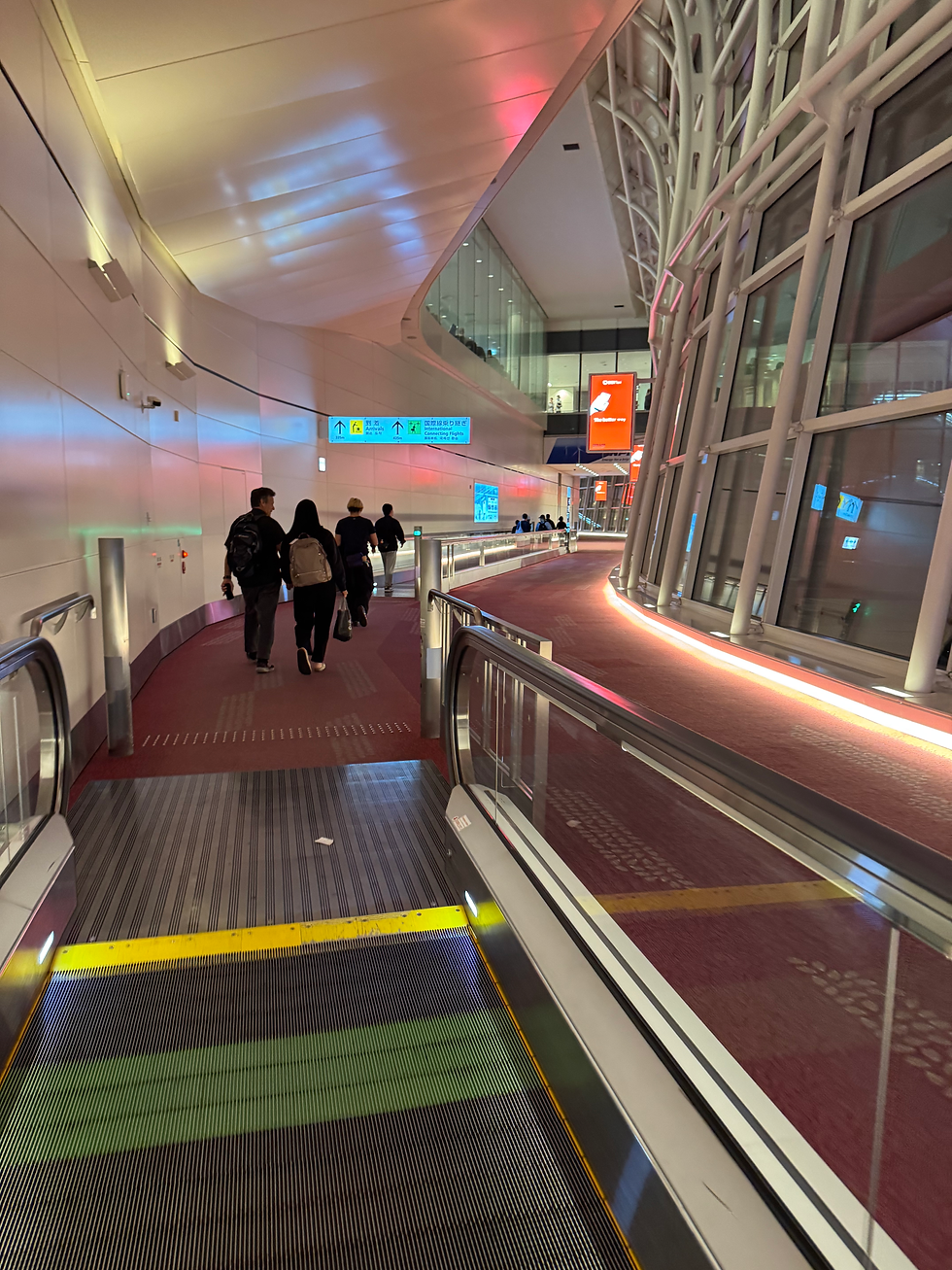 Eye-level view of Haneda Airport terminal with travelers and planes outside