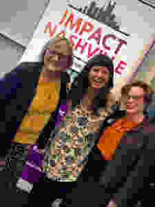 Jane, Anna, and Sheri stand in front of Impact Nashville banner