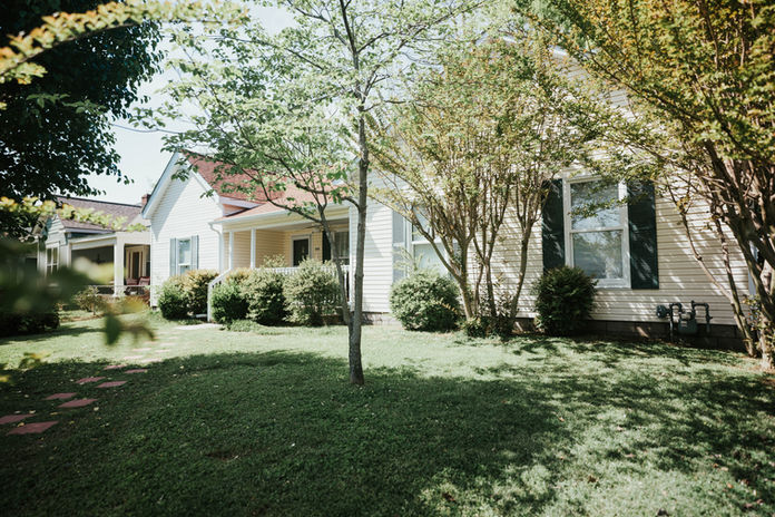 The guest house, a yellow home with dark green shutters.