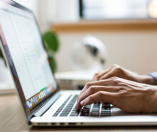 man using a laptop writing