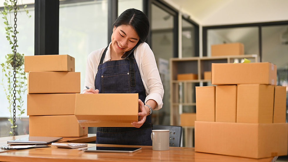 A woman packing boxes for storage for a small business.