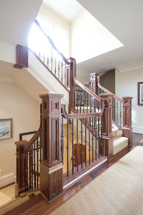 Custom staircase with wood railings designed by CHI Construction