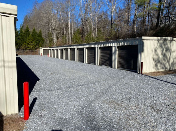 Image capturing the wide driveways and roll up doors of A&G Storage Solutions with tidy, brown-door units.