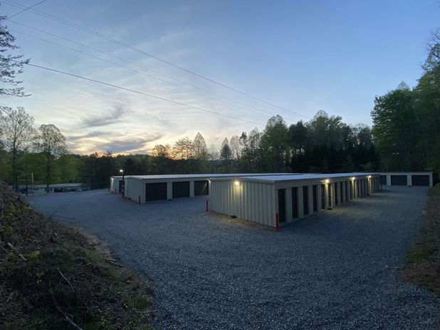 Evening Perspective of A&G Storage's clean, well-lit facility featuring secure storage buildings with brown doors in Blue Ridge area.