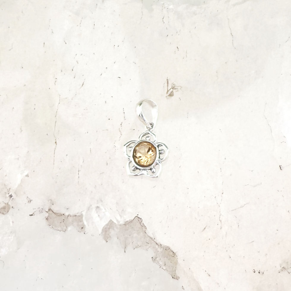 Small silver flower shaped pendant with clear yellow stone.
