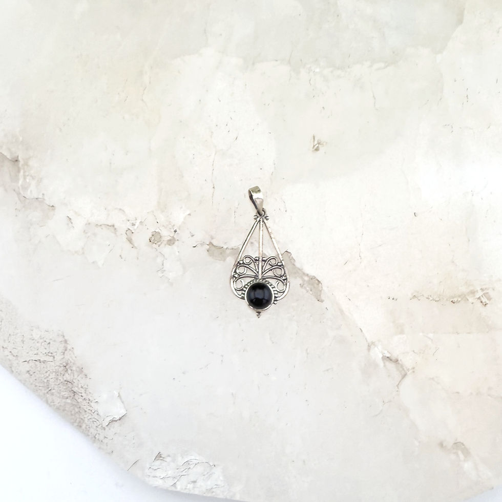 Silver pendant. teardrop shape with filigree. black stone.