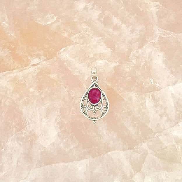 Thumbnail: teardrop shaped silver pendant with silver filigree. orange stone.