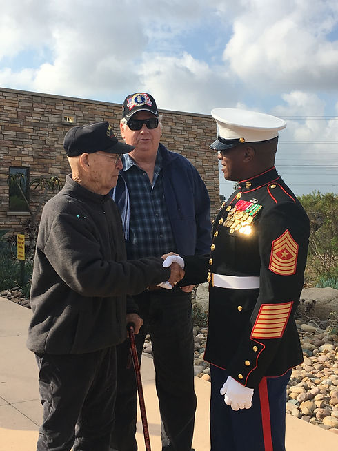War world 2 veteran shaking hands with a Marine