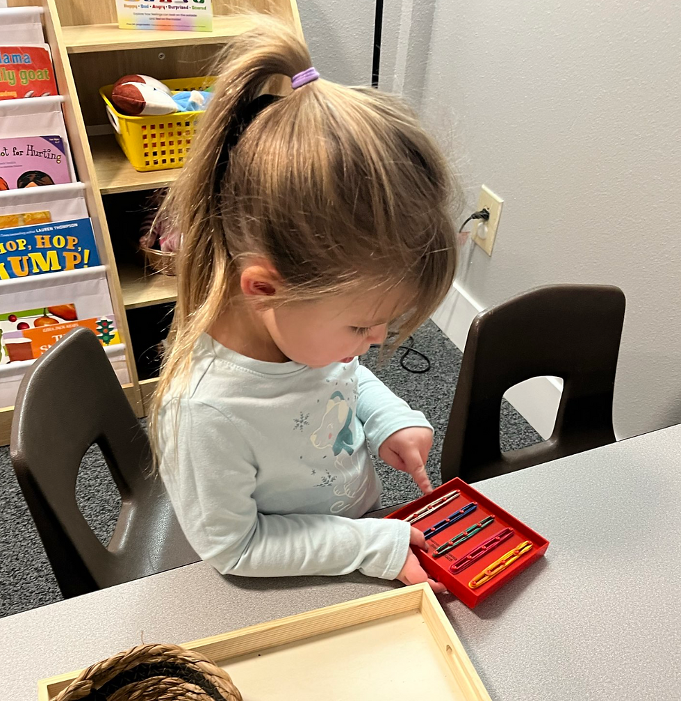 Close-up view of preschool teacher arranging colorful learning blocks