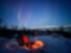 aurora borealis forest snow campfire night