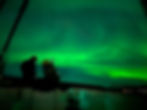 taking photo of northern lights from a boat