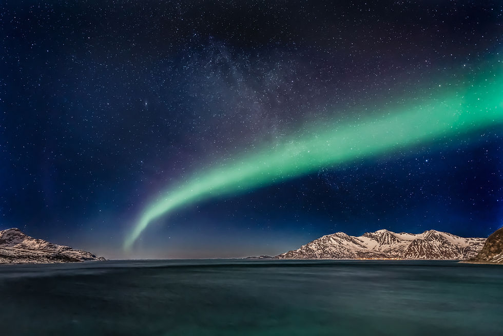 Aurora borealis visible above yacht during private cruise in Tromsø