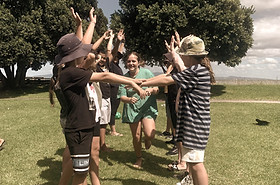 Girl runs down a line of students