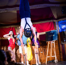 A performer showcasing extraordinary strength and balance, holding a gravity-defying pose on a sleek hand balance apparatus, exuding strength and poise at Sydney Fringe Festival.