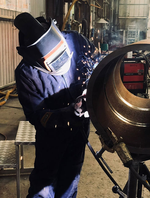 Welder working on tube.jpeg