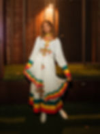 melat wearing traditional ethiopian dress and cowgirl boots