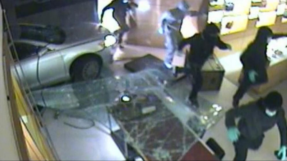 Surveillance photo of smash and grab mob in store.