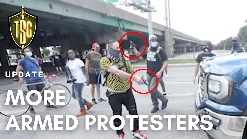 Two BLM protesters in Indianapolis brandish handguns to stop a driver in a vehicle.