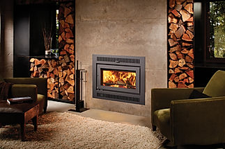 warm room with concrete stone wood burning fireplace
