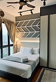 A beautiful room with pillow and blanket next to a window at The Aurea Loft